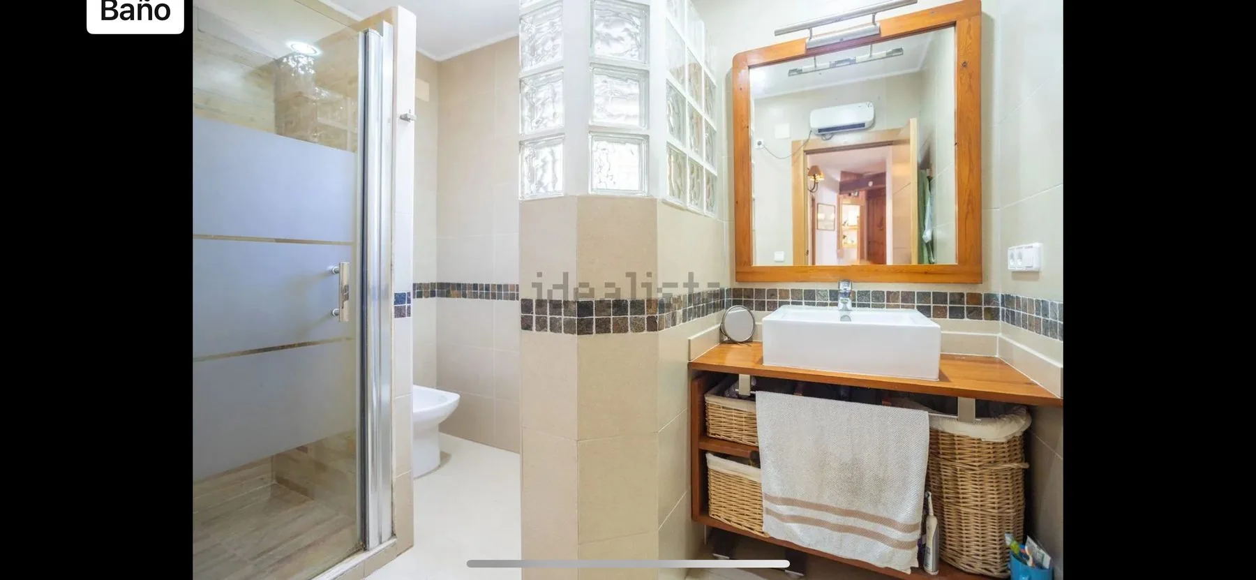 Original bathroom before renovation, showing existing fittings and tiled walls