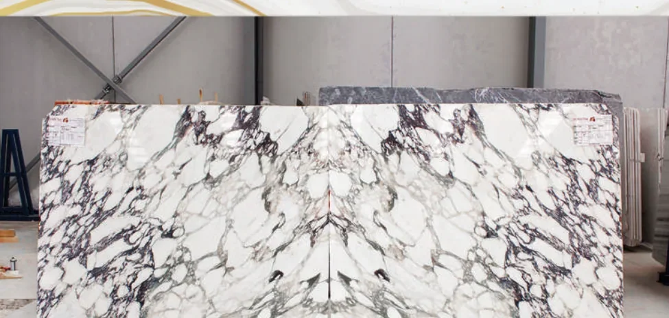 Calacatta Viola natural marble slab in a white and burgundy pattern