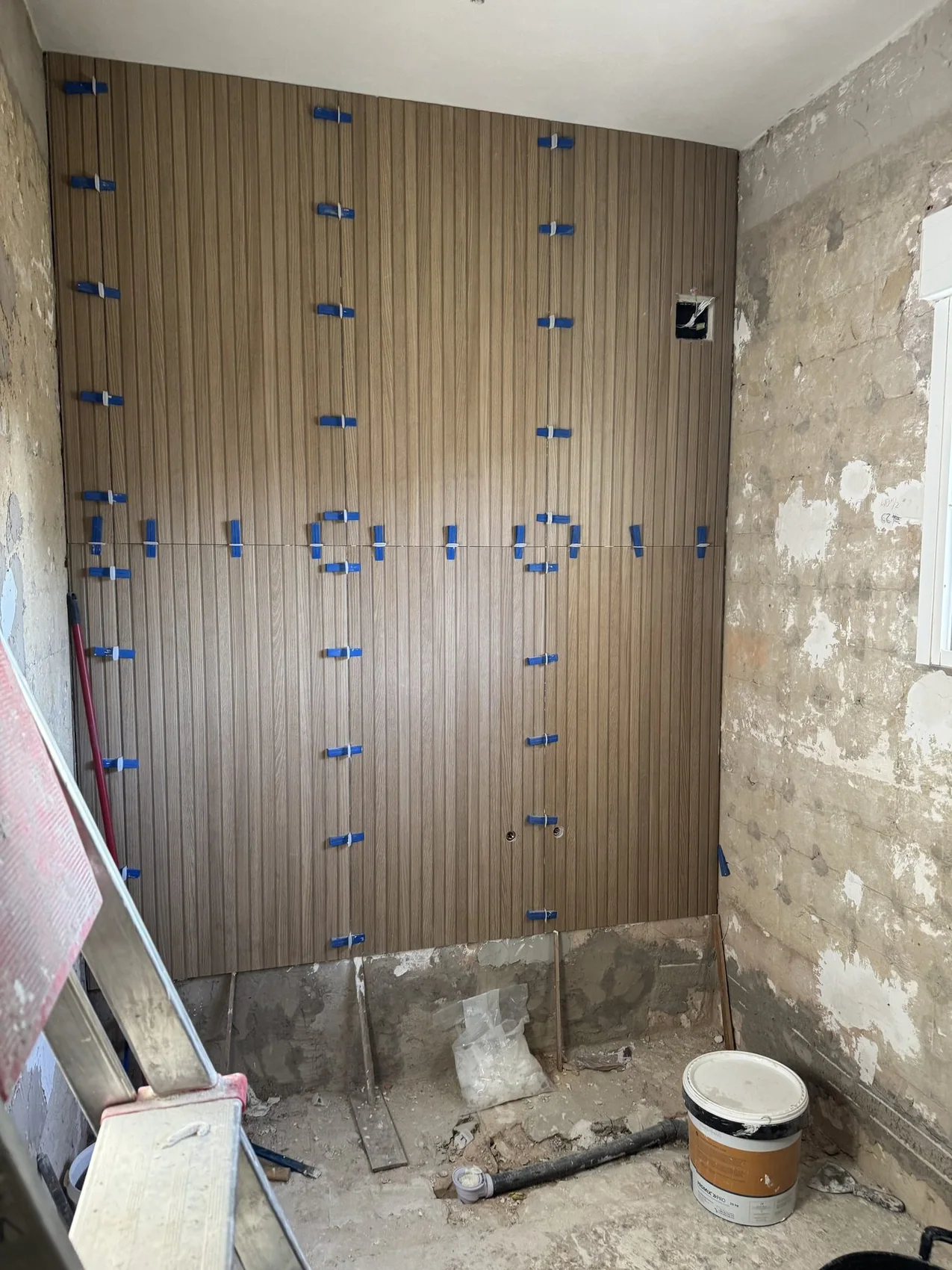 Real bathroom renovation in progress showing finish installation work